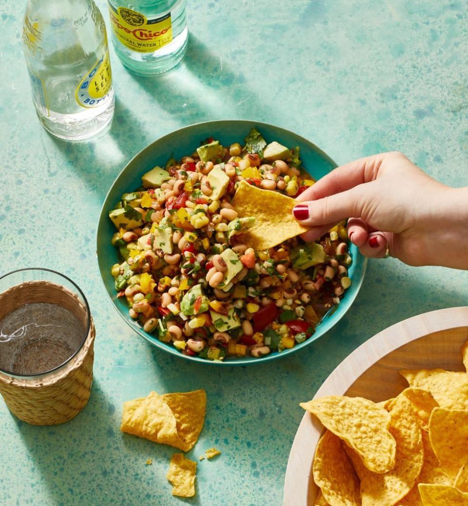 <p>This bright, fresh dip is packed with beans and veggies to balance out all the cheese on the snack table.</p><p>Get the <a href="https://www.goodhousekeeping.com/food-recipes/healthy/a31912730/cowboy-caviar-recipe/" rel="nofollow noopener" target="_blank" data-ylk="slk:Cowboy Caviar recipe;elm:context_link;itc:0;sec:content-canvas" class="link "><strong>Cowboy Caviar recipe</strong></a>.</p>