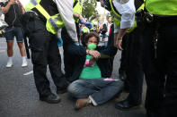 Police officers remove an Extinction Rebellion protester in Parliament Square, Westminster, London. (Photo by Jonathan Brady/PA Images via Getty Images)