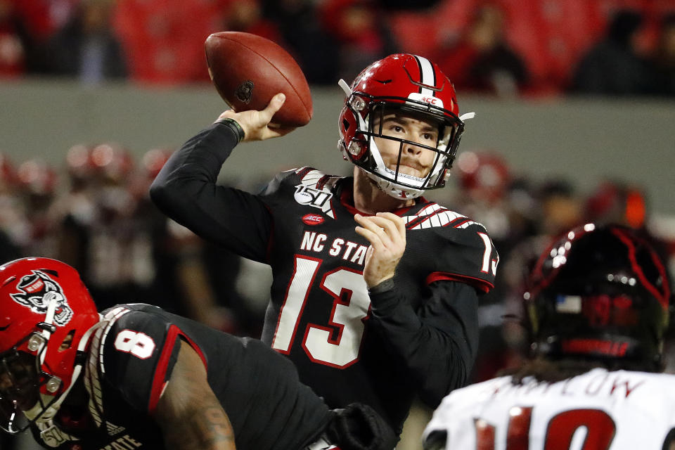 FILE - In this Nov. 16, 2019, file photo, North Carolina State's Devin Leary (13) passes the ball against Louisville during the first half of an NCAA college football game in Raleigh, N.C. The Wolfpack will try to regroup after winning just four games last season. (AP Photo/Karl B DeBlaker, File)