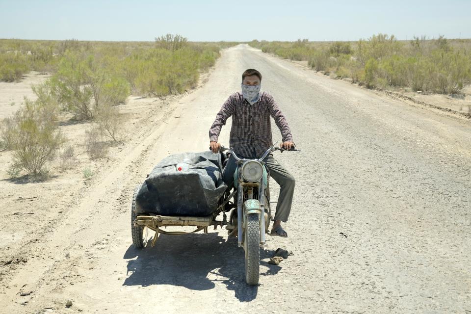 A man rides in desert that used to be part of the bed of the Aral Sea, outside Muynak, Uzbekistan, Monday, June 26, 2023. (AP Photo/Ebrahim Noroozi)