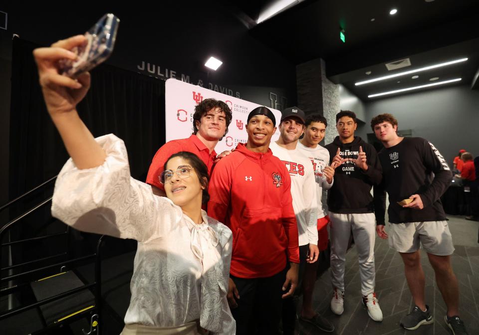 Wed Wabari a takes selfie with Utah Utes football players at a Crimson Collective truck giveaway to scholarship players at Rice-Eccles Stadium in Salt Lake City on Wednesday, Oct. 4, 2023. | Jeffrey D. Allred, Deseret News