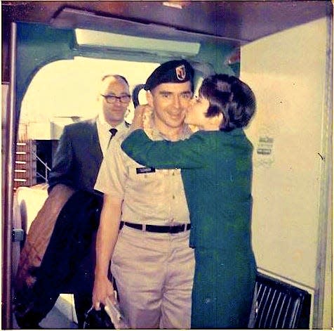 Army Special Forces Capt. Frank Lennon is surprised by his girlfriend, United Airlines stewardess Kathy Huckaby, as he boarded his flight in Honolulu in July 1968. Soldiers who voluntarily extended their combat tours received an extra 30 days paid leave, and Lennon was headed home between tours.