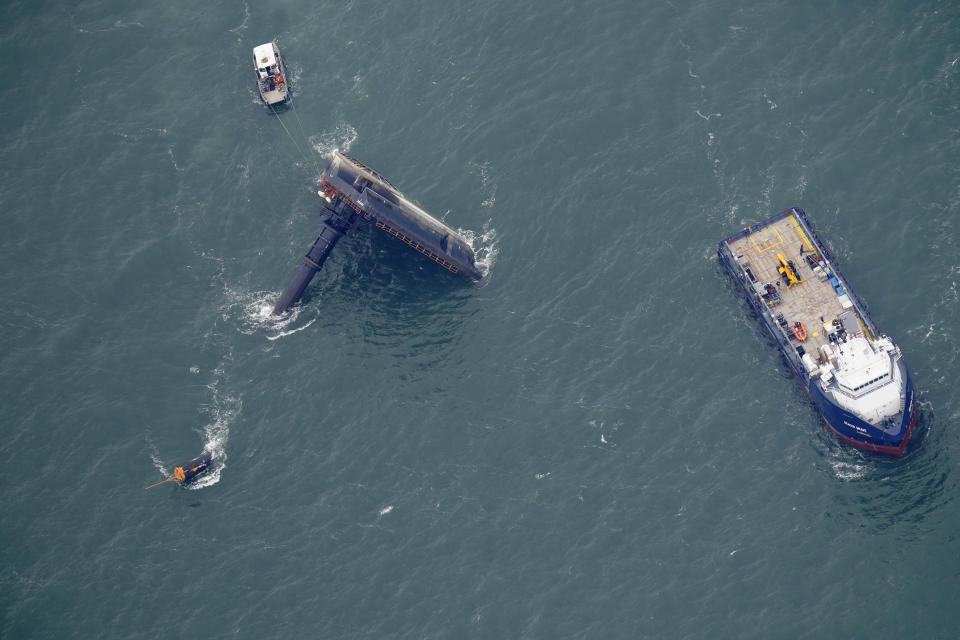 Rescue boats are seen next to the capsized lift boat Seacor Power seven miles off the coast of Louisiana in the Gulf of Mexico Sunday, April 18, 2021. The vessel capsized during a storm on Tuesday. (AP Photo/Gerald Herbert)