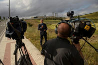 Journalists broadcast outside the prison where three of the five men cleared of gang rape of a teenager and convicted of a lesser crime of sexual abuse are due to leave jail after being granted provisional release in Pamplona, Spain, June 22, 2018. REUTERS/Pablo Lasaosa