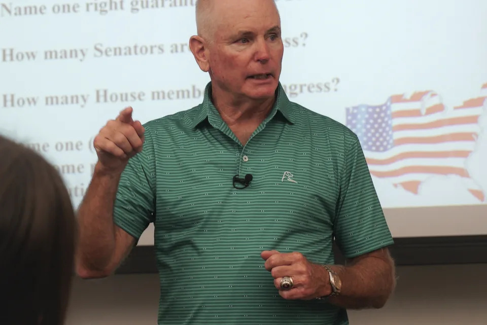 Professor Kevin Dopf lectures his American government students at the University of South Carolina Beaufort in Bluffton, S.C., on Tuesday, Aug. 20, 2024. The retired Arny lieutenant colonel always surprises his students on the first day with a citizenship test, and most of his students flunk. (AP Photo/Allen G. Breed)