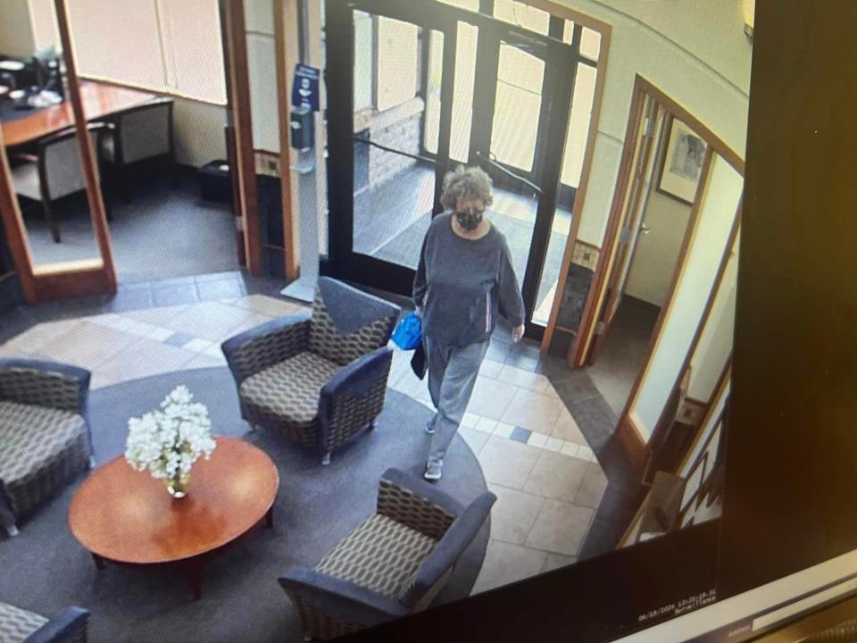 Security footage captures Ann Mayers entering AurGroup Financial Credit Union Friday.