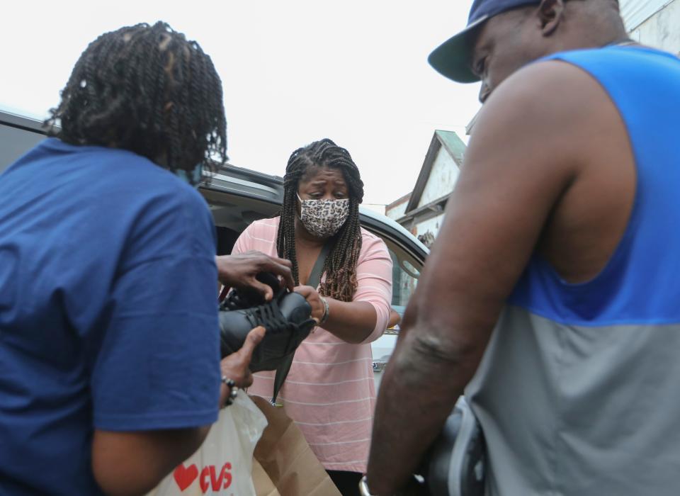 Stacey Henry distributes clothes and other donated supplies to Wilmington victims of flooding Sept. 9, 2021.