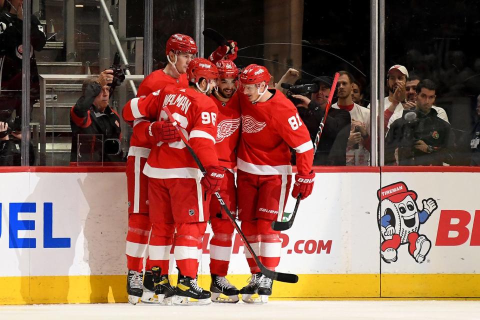 Red Wings center Joe Veleno (90) celebrates with defenseman Jake Walman (96), left winger Dominik Kubalik (81) and left winger Elmer Soderblom (85) after scoring a goal Dec. 17, 2022 against the Ottawa Senators in the first period at Little Caesars Arena.