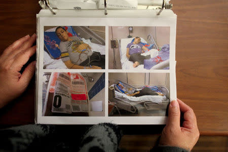 Puerto Rican Nydia Irizarry, 45, shows photographs of her daughter Keyshla Betancourt, 22, who suffers from brain cancer, as she receives treatment for cancer at a hospital in Puerto Rico, in Orlando, Florida, U.S., December 6, 2017. REUTERS/Alvin Baez