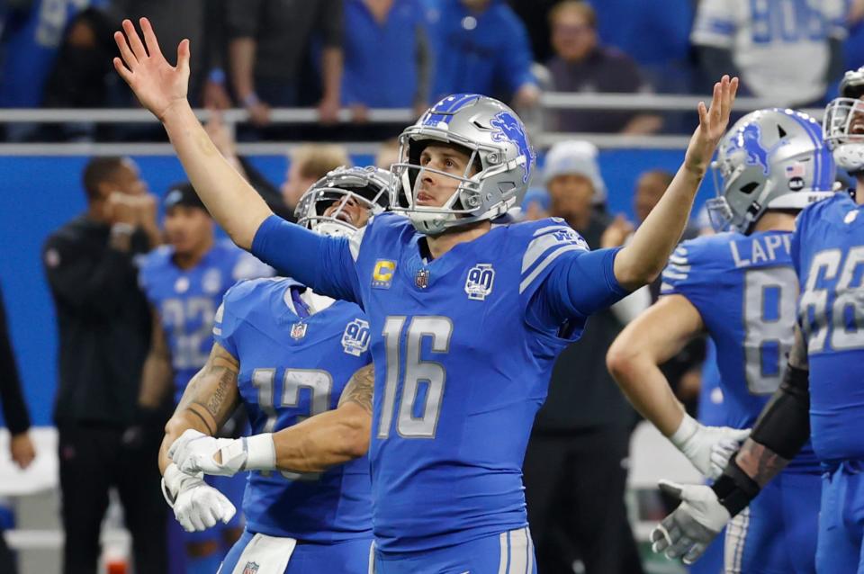 Detroit Lions quarterback Jared Goff (16) raises his arms as the Lions beat the L.A. Rams, 24-23, in the wild-card round of the NFL playoffs at Ford Field in Detroit on Sunday, Jan. 14, 2024.