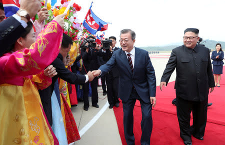 South Korean President Moon Jae-in and North Korean leader Kim Jong Un attend an official welcome ceremony at Pyongyang Sunan International Airport, in Pyongyang, North Korea, September 18, 2018. Pyeongyang Press Corps/Pool via REUTERS