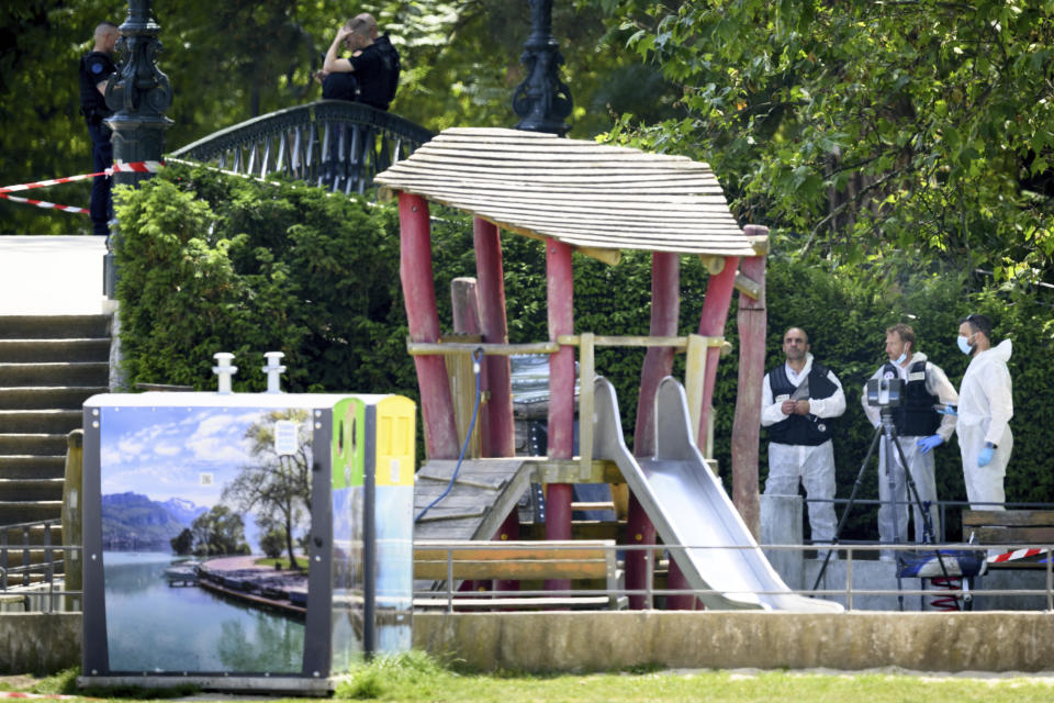 CORRECTS SLUG - Security forces gather in a playground at the scene of knife attack in Annecy, French Alps, Thursday, June 8, 2023. An attacker with a knife stabbed several young children and at least one adult, leaving some with life-threatening injuries, in a town in the Alps on Thursday before he was arrested, authorities said. (Jean-Christophe Bott/Keystone via AP)