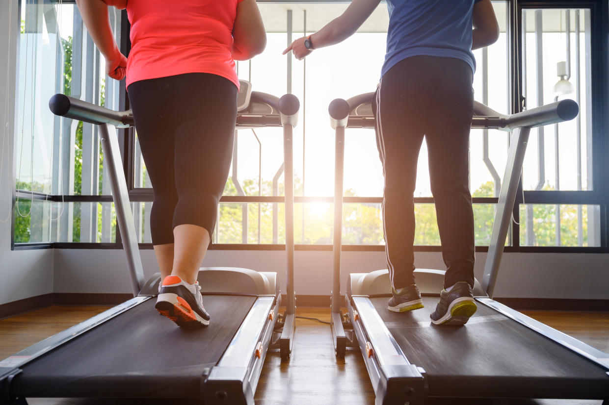 Woman and trainer using treadmills. (Getty Images)