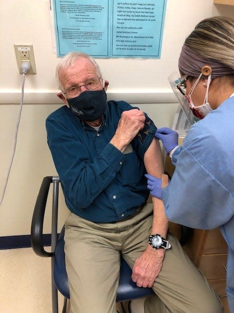 Dr. Richard Watson, an 87-year old volunteer doctor at Zufall Health Center in Dover, receives the Moderna COVID-19 vaccine from medical assistant Erandi Anzures. Wednesday, Dec. 23, 2020.