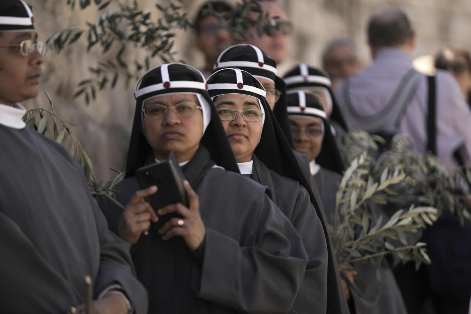 Nuns take part in the Palm Sunday procession on the Mount of Olives in east Jerusalem, Sunday, April 2, 2023. The procession observes Jesus' entrance into Jerusalem in the time leading up to his crucifixion, which Christians mark on Good Friday. (AP Photo/Mahmoud Illean)