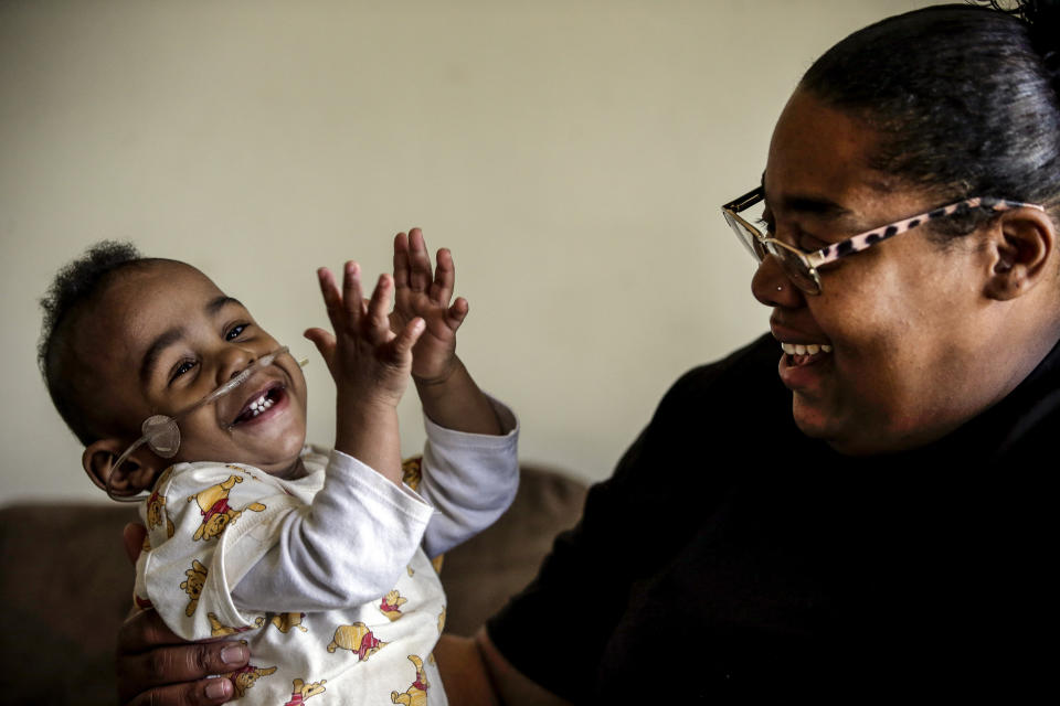 Curtis Means plays with his mother, Michelle Butler, at their home in Eutaw, Ala., on Wednesday, March 23, 2022. After his premature birth, Curtis stayed in the newborn intensive care unit for nine months. Butler made the 90-minute trek from her home in rural Eutaw to Birmingham several times a week. She read books to Curtis and often held him inside her shirt so his skin touched hers. (AP Photo/Butch Dill)