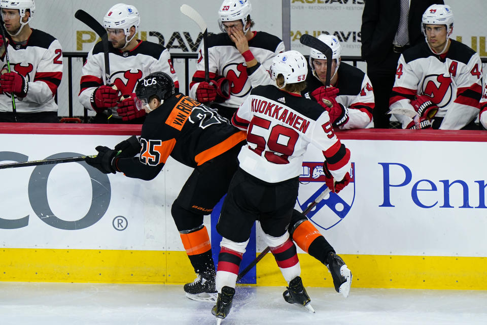 Philadelphia Flyers' James van Riemsdyk, left, and New Jersey Devils' Janne Kuokkanen collide during the third period of an NHL hockey game, Saturday, May 1, 2021, in Philadelphia. (AP Photo/Matt Slocum)