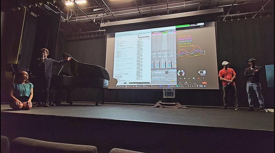 Students Dennis Frank, Muhammad Mustafa and Alexander Zimmer performing brain art. In the background, software converts student performers’ brainwaves into music and water turbulence in a tank designed by professor Chris Lai. Francesco Fedele