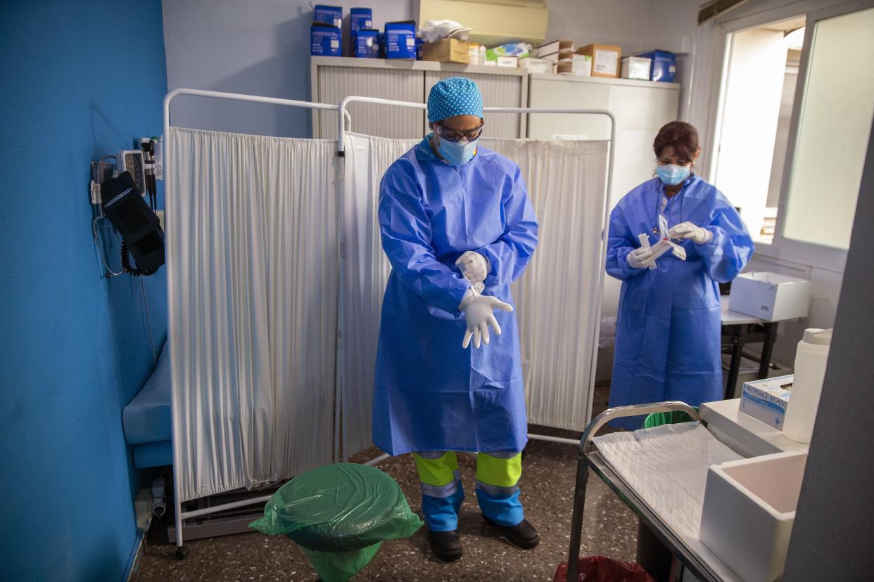 Health workers get ready to take samples for PCR tests for the COVID-19 at a medical center in Madrid, Spain on Monday, Aug. 17, 2020. New daily cases of the coronavirus have been steadily climbing since Spain ended a more than three-month national lockdown on June 21.