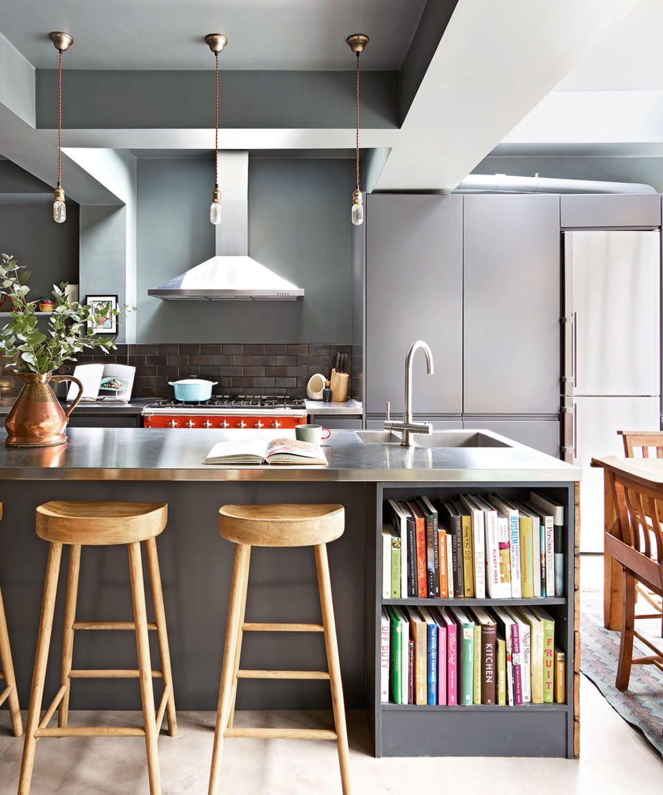 kitchen island with steel countertop and bookshelves