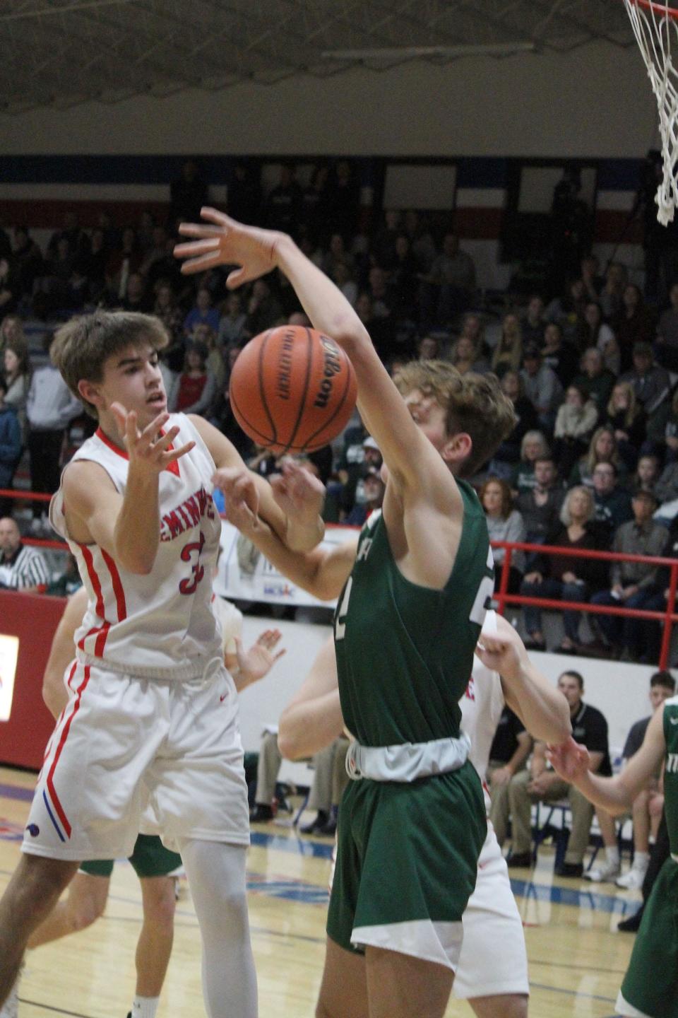 Monrovia senior Austin Leeds blocks a shot from Eminence junior Hayden Holley during Wednesday's Powder Keg game at Eminence.