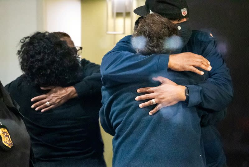 FILE PHOTO: People embrace after learning that their loved one was safe after a mass casualty shooting at the FedEx facility in Indianapolis