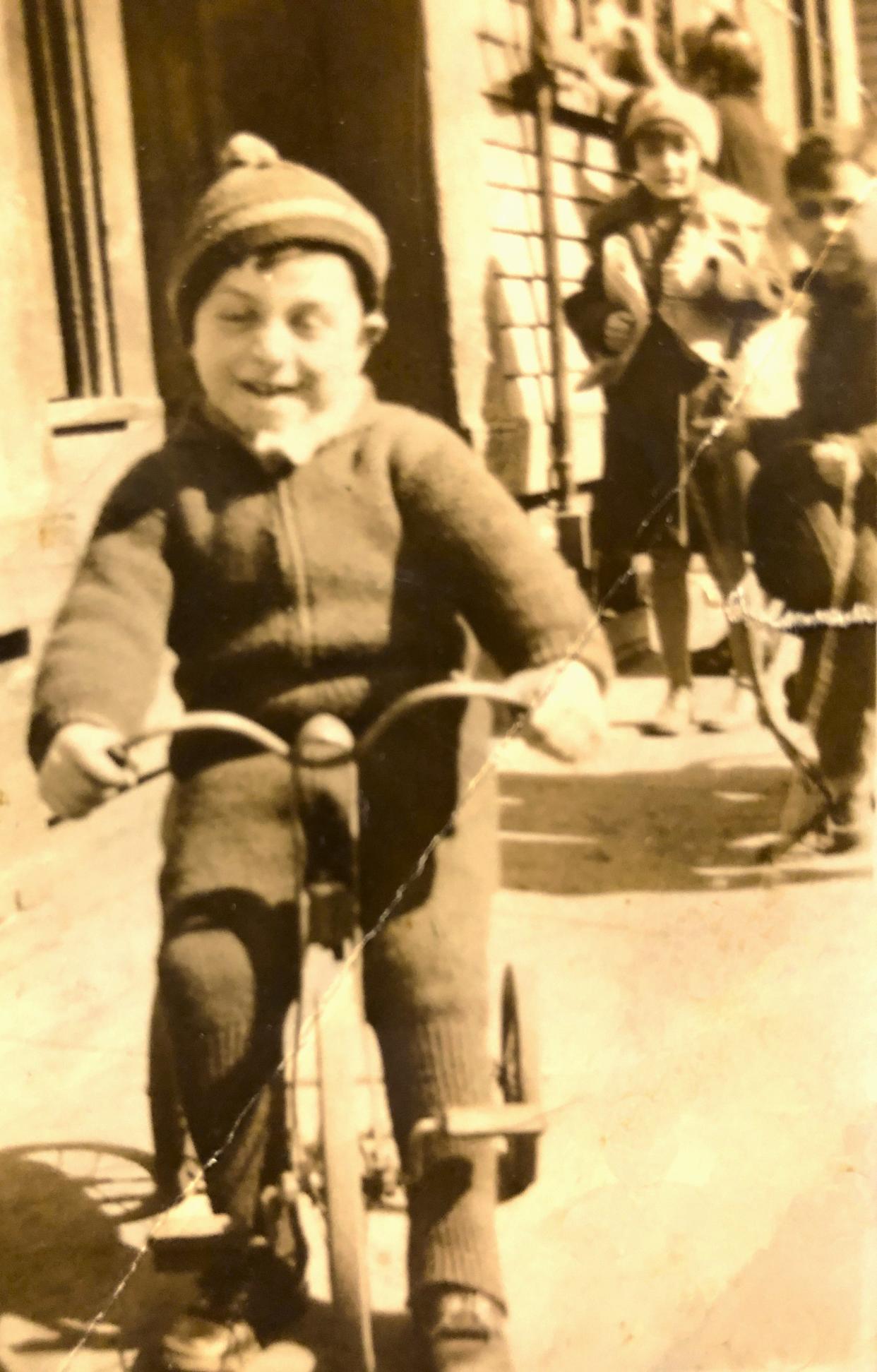 Carmine "Charlie" Mazzulli rides his bike in South Boston with friends.