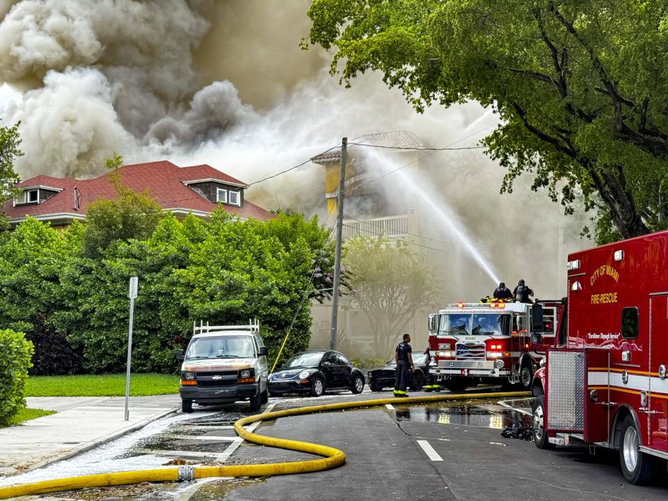 Miami Fire Rescue and Miami police work at the scene of the fire at the Temple Court Apartments, Monday, June 10, 2024 in Miami. (Carl Juste/Miami Herald via AP)