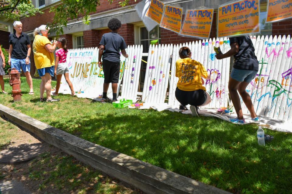 People painting at the 2021 Juneteenth event for  Families Organizing for Racial Justice at Newton North High School.