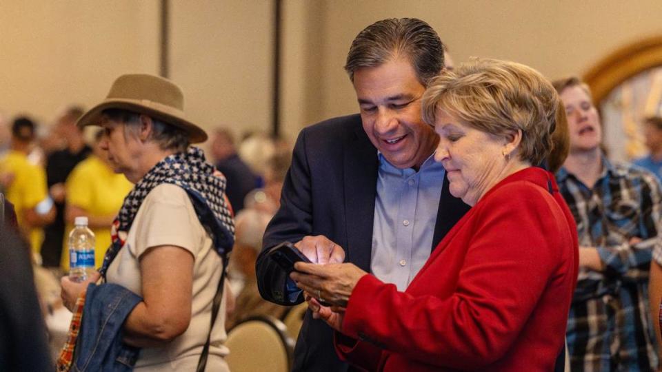 Idaho Attorney General Raúl Labrador and his wife Rebecca Labrador check results at the GOP election party on Tuesday.