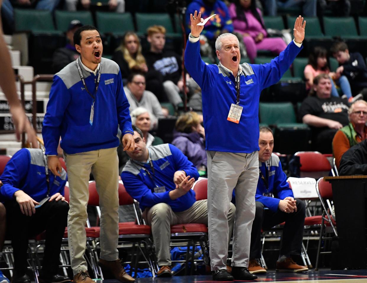 Irondequoit coach Kyle Trevas, center, was the JV coach and varsity assistant on the Eagles' run to the state championship game. During Irondequoit's 50-29 win over South Side (Section VIII) in the 2023 Class A state semifinals, Trevas observes from his seat as coaches Derrick Kemp, left, and Chris Cardon, right, communicates with the team on the court.