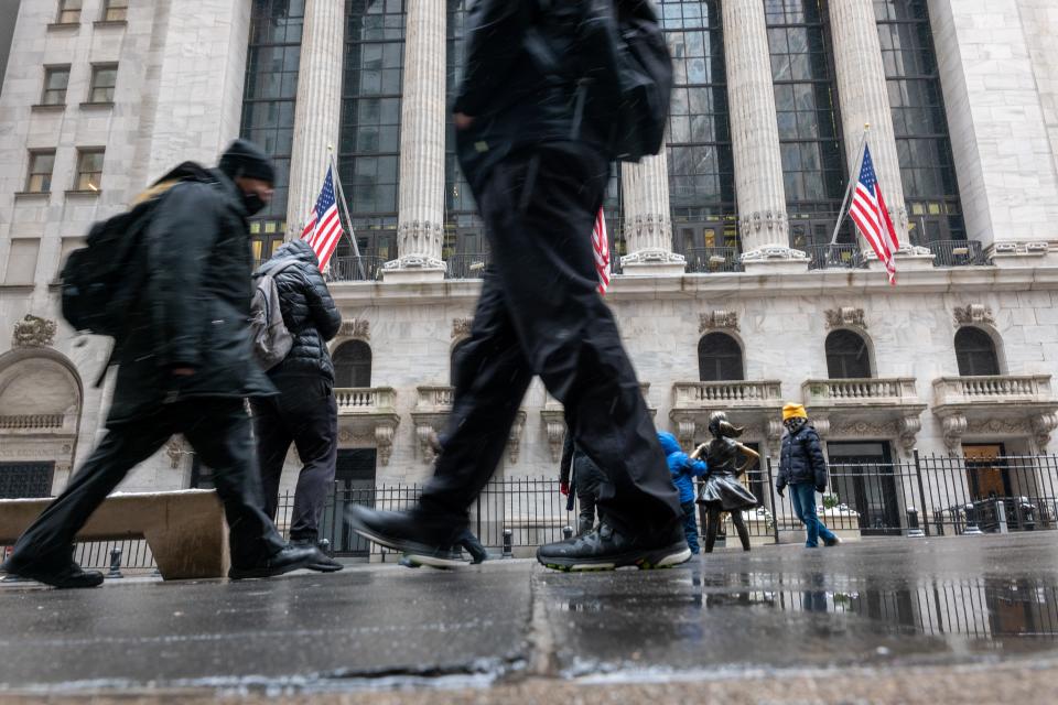 People walk by the New York Stock Exchange (NYSE) on Jan. 19, 2024 in New York City.