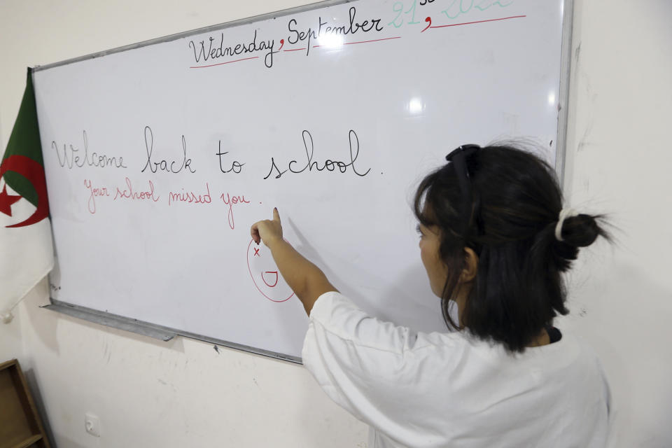 A teacher gives an English lesson in a private school of Birkhadem, outside Algiers, Wednesday, Sept.21, 2022. Algerian children went back to school Wednesday Sept. 21, 2022 for the first time since the president last month ordered schools to switch from teaching French as a second language alongside Arabic to English instead. The government says the move is a modernization effort but it is also seen as a way for Algeria to distance itself from its past as a French colony. (AP Photo/Fateh Guidoum)