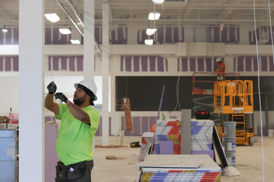Inlet Mechanical supervisor Johnny Raqueta works on the air conditioning system in the new Planet Fitness at the Gateway Plaza, the former Kmart plaza at the corner of U.S. 1 and Virginia Avenue, on Wednesday, Jan. 10, 2024, in Fort Pierce. Developer Rebecca Miller, president of Miller Permitting & Land Development, said the gym should be completed in mid-February. Other business that have committed so far – Burlington, Ross Dress for Less, Bravo Supermarkets, Five Below, dd's Discounts, T-Mobile and America's Best Contacts & Eyeglasses – are expected to open by the end of the year.