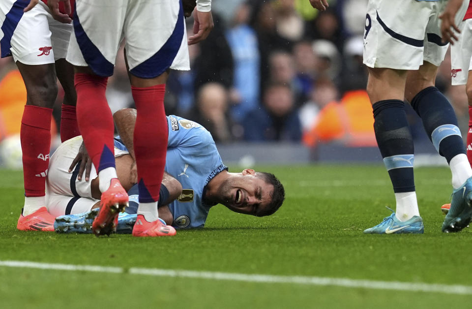 Manchester City's Rodri reacts to an injury, during the English Premier League soccer match between Manchester City and Arsenal at the Etihad stadium in Manchester, England, Sunday, Sept. 22, 2024. ( Martin Rickett/PA via AP)