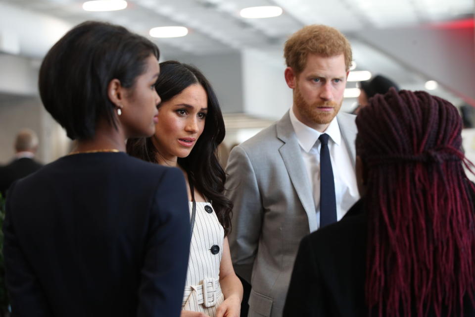 Prince Harry and Meghan talk with delegates during a reception for the Commonwealth Youth Forum in April (PA)