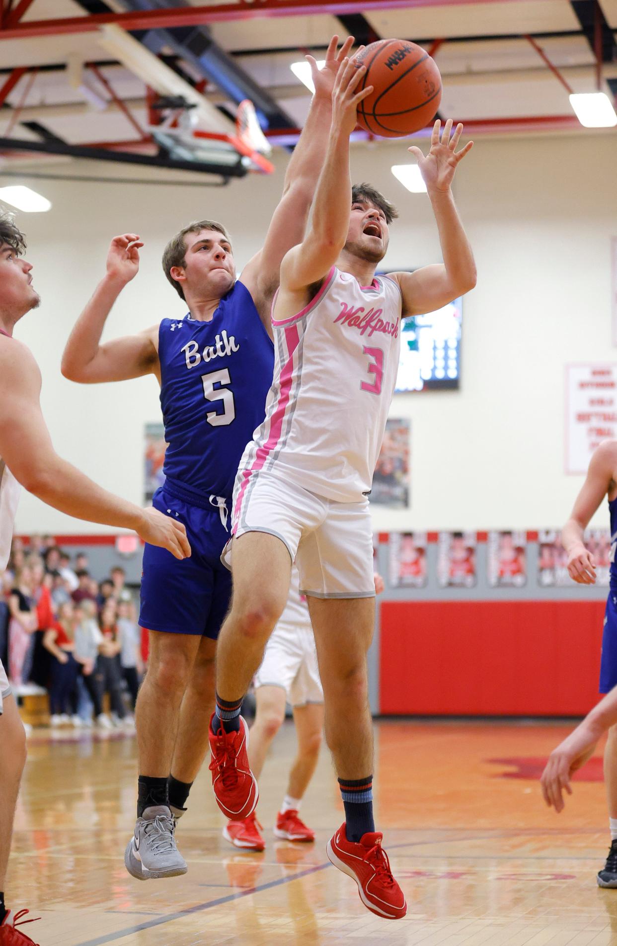 Laingsburg's Cameron Ballard, right, shoots against Bath's Sam Wonch, Tuesday, Feb. 20, 2024, in Laingsburg.