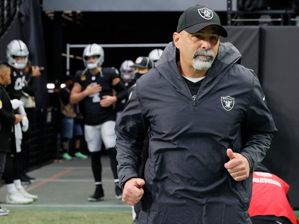 Rich Bisaccia takes the field ahead of a game against the Denver Broncos.