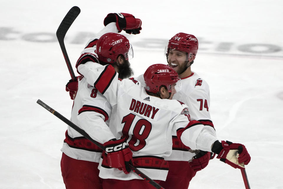 Carolina Hurricanes defenseman Brent Burns, left, celebrates with Jack Drury (18) and Jaccob Slavin (74) after scoring a goal during the third period of an NHL hockey game against the Florida Panthers, Thursday, April 13, 2023, in Sunrise, Fla. (AP Photo/Lynne Sladky)