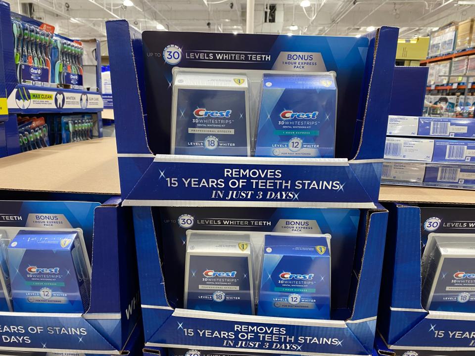 Packs of Crest whitening strips in blue packaging and display
