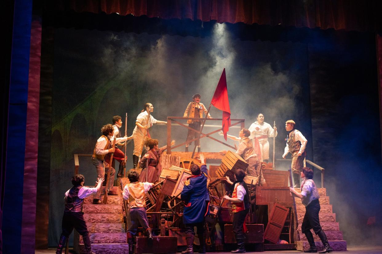 Sophia Bernard as Gavroche collapses after being struck by a bullet in a scene from "Les Miserables (School Edition)" at the Croswell Opera House.