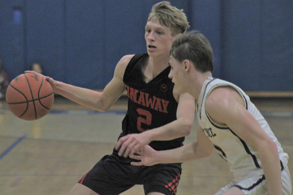 Onaway senior guard Jadin Mix (left) looks to get past St. Ignace senior guard Jonny Ingalls during the first half of Tuesday's MHSAA Division 4 boys basketball regional semifinal at Inland Lakes. Mix finished with a career-high 38 points in his final game as a Cardinal.