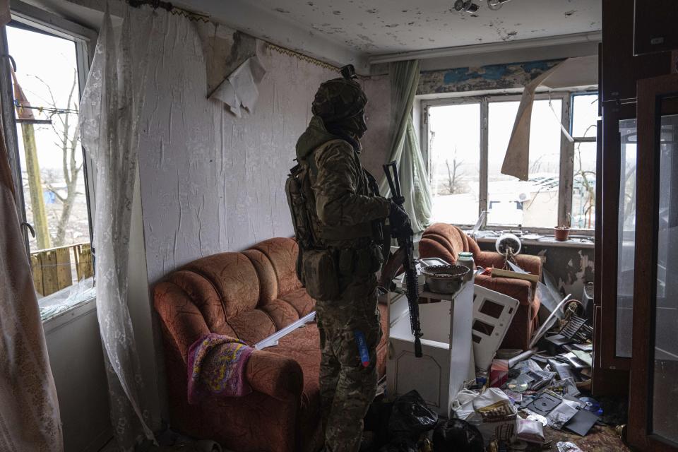 A Ukrainian marine serviceman looks on the positions of Russian forces during a patrol in the frontline city of Vuhledar, Ukraine, Saturday, Feb. 25, 2023. (AP Photo/Evgeniy Maloletka)