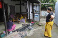 Diana Khumanthem, 30, watches her three-year-old nephew Hridhaan, who she has decided to raise as her own after his mother Ranjita died of COVID-19, at home in Imphal, in Manipur, India, Monday, June 28, 2021. Diana lost both her mother and sister to the virus in May. Treatment costs wiped out the family's savings, and when the private hospital where she died wouldn’t release her sister’s body for last rites until a bill of about $5,000 was paid, she pawned the family's gold jewelry to moneylenders. When that wasn’t enough, friends, relatives and her sister’s colleagues helped. She still owes some $1,000. (AP Photo/Yirmiyan Arthur)