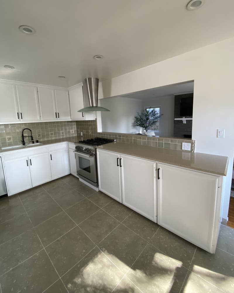 white kitchen with brown tile floor before makeover