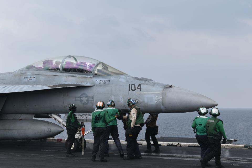 Sailors work on the flight deck of the USS Dwight D. Eisenhower.