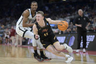 Charleston guard Ryan Larson (11) drives to the basket while defended by San Diego State guard Micah Parrish (3) during the first half of a first-round college basketball game in the NCAA Tournament, Thursday, March 16, 2023, in Orlando, Fla. (AP Photo/Phelan M. Ebenhack)
