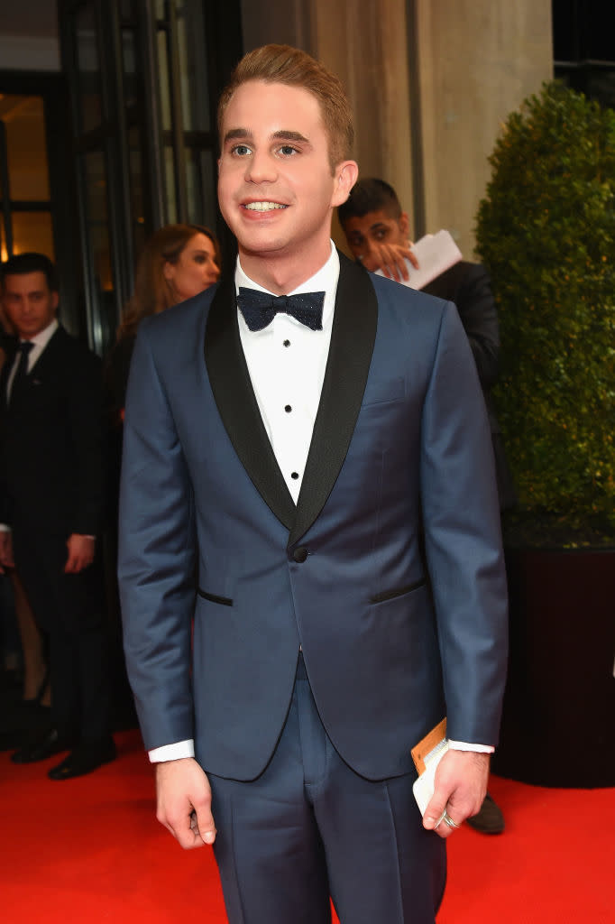 Ben in a tuxedo with bow tie smiling on red carpet