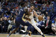 Cleveland Cavaliers forward Kevin Love (0) dribbles as New Orleans Pelicans forward Zion Williamson (1) defends during the first half of an NBA basketball game in New Orleans on Friday, Feb. 28, 2020. (AP Photo/Rusty Costanza)