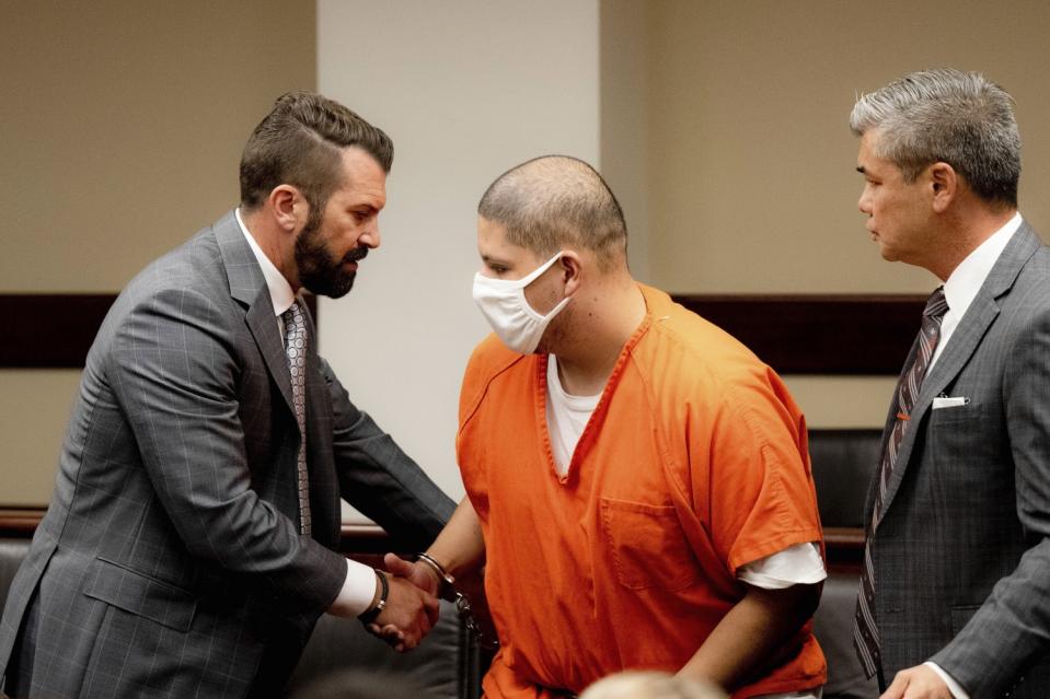 Joseph Jimenez, 20, center, is greeted by his attorneys Philip Greenberg, left, and Charles Kenyon during his arraignment.